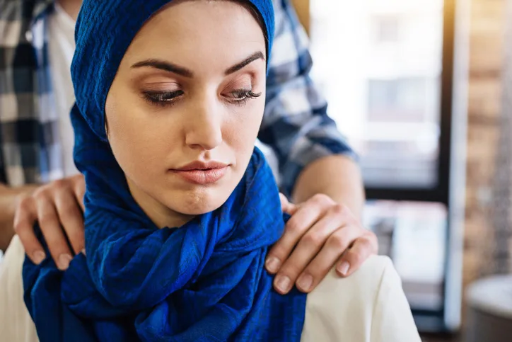 Muslim woman beign herrased by representative of another group