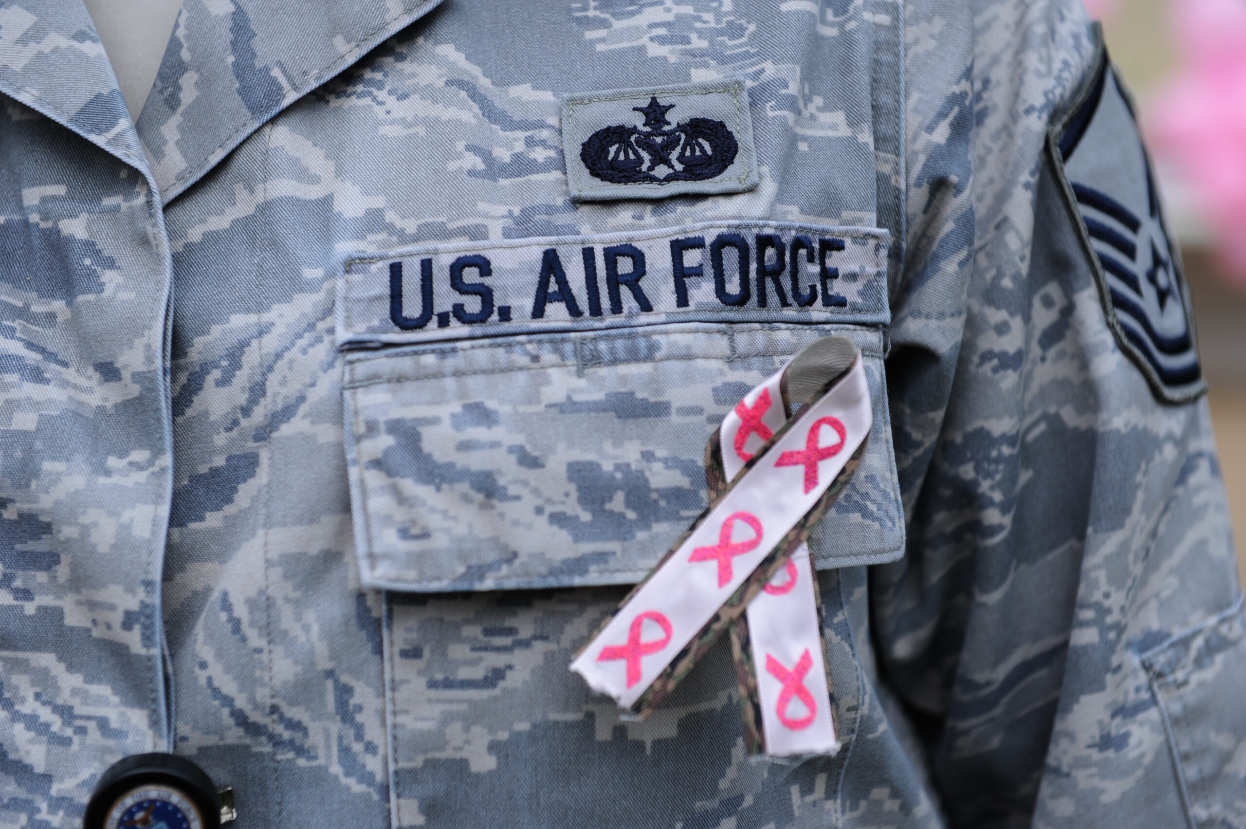 A U.S. airman wears a pink ribbon in support of the Dilorenzo Clinic's Breast Cancer Awareness Walk/Run event in the Pentagon's center courtyard, Washington, D.C., Oct. 24, 2013. Department of Defense civilians and service members and breast cancer survivors participated in the walk to raise awareness for breast cancer. (U.S. Army photo by Eboni Everson-Myart/Released)